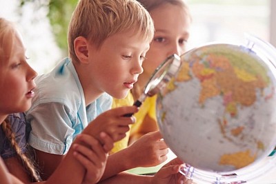 Kids searching the globe